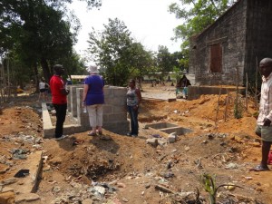 Community toilet block with cesspit behind